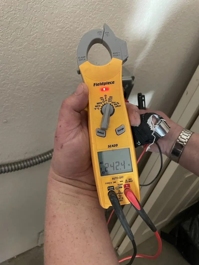 Voltage testing with clamp meter during Recessed Lighting Installation in Garden City